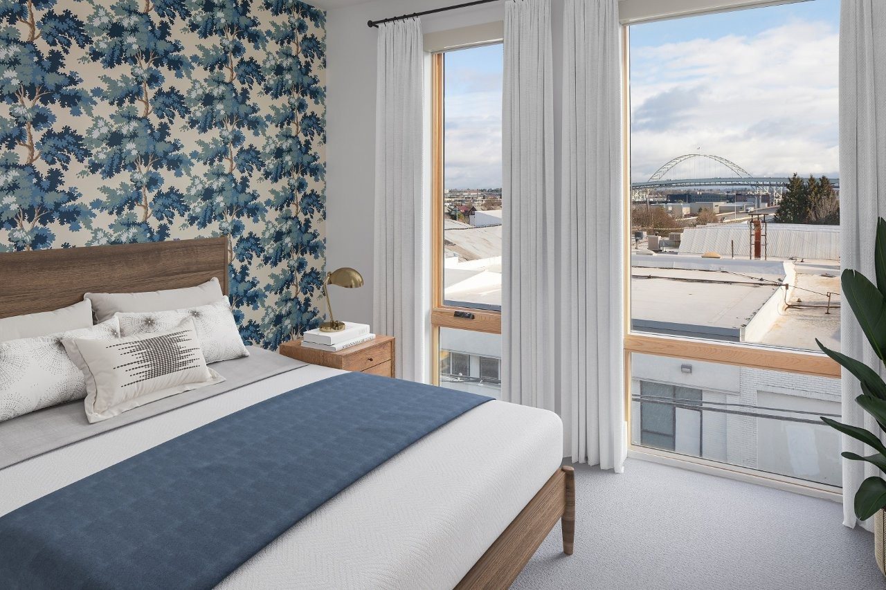 A bedroom with a large bed and a view of a bridge.